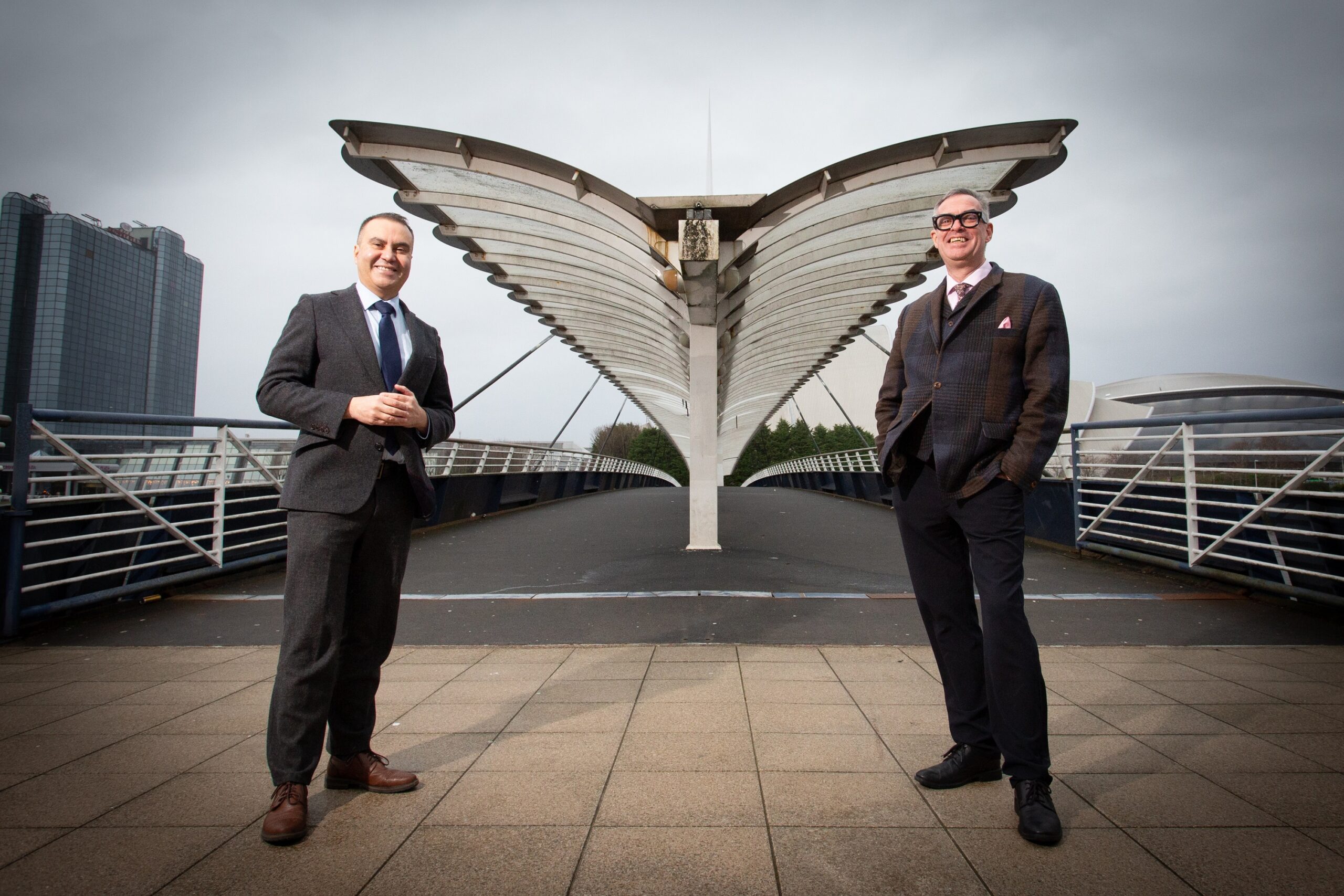 Immigration Law with Paulo de Moura - Picture of Paulo de Moura and Brian Inkster standing in front of a bridge with wing like structure /shelter over it -Inksters Solicitors